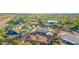 A high-angle aerial view highlights the lush neighborhood surrounding the single-story home with desert landscaping at 2319 N 58Th St, Scottsdale, AZ 85257