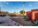 Spacious brick patio backyard with desert landscaping, trees, and tall palm tree at 2319 N 58Th St, Scottsdale, AZ 85257
