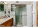 Luxurious bathroom with glass shower, natural stone tile, and double sinks at 2319 N 58Th St, Scottsdale, AZ 85257