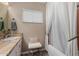 Bright bathroom features a marble countertop, white cabinets and a shower with white curtains at 2319 N 58Th St, Scottsdale, AZ 85257
