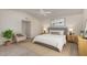 Neutral bedroom with light colored chair, white ceiling fan, and light wood colored bedside tables and dresser at 2319 N 58Th St, Scottsdale, AZ 85257
