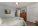 Bedroom with a queen-sized bed, wooden dresser, and blue walls at 2319 N 58Th St, Scottsdale, AZ 85257