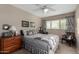 Comfortable bedroom features a queen-sized bed, plush pillows, ceiling fan, and natural light from the window at 2319 N 58Th St, Scottsdale, AZ 85257