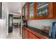 Butler's pantry featuring wood cabinets, granite counters, and glass door cupboards at 2319 N 58Th St, Scottsdale, AZ 85257