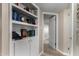 Hallway with built-in shelves, hardwood floors, and access to other rooms at 2319 N 58Th St, Scottsdale, AZ 85257