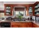 Bright kitchen featuring wood cabinets, double sink, granite counters, stainless appliances, and window view at 2319 N 58Th St, Scottsdale, AZ 85257