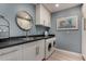 Functional laundry room with a black countertop, white cabinets, and a washer and dryer at 2319 N 58Th St, Scottsdale, AZ 85257