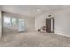 Spacious living room with neutral carpet, a ceiling fan and sliding glass doors to the backyard at 2319 N 58Th St, Scottsdale, AZ 85257
