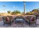 Outdoor patio with brick flooring has 2 couches, 2 chairs, small table, and desert landscaping at 2319 N 58Th St, Scottsdale, AZ 85257