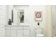 Clean bathroom with white cabinets, contemporary fixtures, and neutral decor at 23361 W Atlanta Ave, Buckeye, AZ 85326