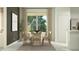 Chic dining area featuring modern table with six chairs, sleek decor, and natural light from the window at 23361 W Atlanta Ave, Buckeye, AZ 85326