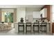 Modern kitchen featuring sleek white cabinets, stainless steel appliances, and a breakfast bar overlooking the dining area at 23361 W Atlanta Ave, Buckeye, AZ 85326