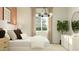 Bright bedroom featuring a comfortable bed, elegant decor, and a large window providing natural light at 23361 W Atlanta Ave, Buckeye, AZ 85326