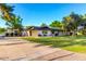 Charming single-story home featuring a well-manicured lawn and mature trees at 2350 E Melrose St, Gilbert, AZ 85297