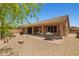 Backyard featuring a desert landscape, covered patio, and seating area, perfect for outdoor relaxation at 2422 W Maya Way, Phoenix, AZ 85085