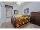 Cozy bedroom with colorful bedding, carpet flooring, matching window valance, and natural light at 2422 W Maya Way, Phoenix, AZ 85085