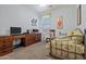 Comfortable bedroom with a metal frame bed, carpet flooring, and a wooden desk at 2422 W Maya Way, Phoenix, AZ 85085