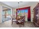 A dining room with a wood table, matching chairs, and a window looking out to the backyard at 2422 W Maya Way, Phoenix, AZ 85085