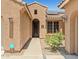Welcoming front entrance with detailed door, desert landscaping, and solar panels above the front window at 2422 W Maya Way, Phoenix, AZ 85085
