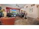 Cozy living room featuring comfortable leather sofas, large windows, and tile flooring throughout at 2422 W Maya Way, Phoenix, AZ 85085