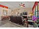 Bright living room with cozy leather sofas, media center, and plenty of space for entertaining guests at 2422 W Maya Way, Phoenix, AZ 85085
