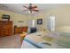 Main bedroom showcasing a bed with decorative pillows, carpet floor, ceiling fan, and lots of natural light at 2422 W Maya Way, Phoenix, AZ 85085