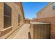 View of the brick paved side yard, enclosed with a fence leading to backyard at 2422 W Maya Way, Phoenix, AZ 85085