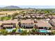 Aerial view of homes with private pools, a neighborhood park, and mountain views at 2460 E Crescent Way, Gilbert, AZ 85298