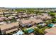 An aerial view of a community with tree-lined streets and homes with private pools on a sunny day at 2460 E Crescent Way, Gilbert, AZ 85298