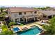 Lush backyard oasis with a pool, spa, fire pit, and covered patio perfect for outdoor gatherings at 2460 E Crescent Way, Gilbert, AZ 85298