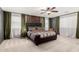 Spacious bedroom features large bed, modern lighting, neutral carpet, and view of the window at 2460 E Crescent Way, Gilbert, AZ 85298