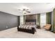 Beautiful bedroom features a large bed, dark grey walls and green curtains near bright windows at 2460 E Crescent Way, Gilbert, AZ 85298