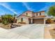 Charming two-story home showcasing a three-car garage and well-maintained desert landscaping at 2460 E Crescent Way, Gilbert, AZ 85298