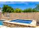 This backyard hot tub is accented by stone and features a basketball hoop at 2460 E Crescent Way, Gilbert, AZ 85298