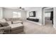 Comfortable living room with a plush sectional sofa, television, and ample natural light at 2460 E Crescent Way, Gilbert, AZ 85298