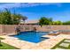 Beautiful backyard pool with basketball hoop, water feature, stone accents, and an in-pool fire pit at 2460 E Crescent Way, Gilbert, AZ 85298