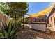 Backyard with hot tub, partial sun shade, mature landscaping, and gravel groundcover at 24813 N 55Th Dr, Glendale, AZ 85310