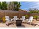 Relaxing backyard patio area featuring a fire pit and four comfortable Adirondack chairs at 24813 N 55Th Dr, Glendale, AZ 85310
