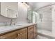 Modern bathroom featuring double sinks, a glass-enclosed shower, and sleek fixtures at 24813 N 55Th Dr, Glendale, AZ 85310