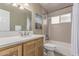 Bathroom featuring updated vanity, granite countertops, framed mirror and bathtub with tiled shower at 24813 N 55Th Dr, Glendale, AZ 85310