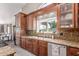 Well-lit kitchen features custom cabinets, granite countertops, and stainless appliances at 24813 N 55Th Dr, Glendale, AZ 85310