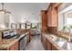 Gourmet kitchen with wooden cabinetry, granite countertops, and stainless steel appliances at 24813 N 55Th Dr, Glendale, AZ 85310