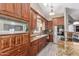 Well-equipped kitchen featuring stainless steel appliances, wooden cabinetry, and elegant granite countertops at 24813 N 55Th Dr, Glendale, AZ 85310
