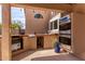 Outdoor kitchen area featuring built-in grill, sink, ice maker and double oven for outdoor entertaining at 24813 N 55Th Dr, Glendale, AZ 85310
