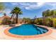 Backyard swimming pool surrounded by lush landscaping and clear blue sky at 24813 N 55Th Dr, Glendale, AZ 85310