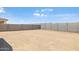 A spacious dirt backyard is enclosed by a sturdy block wall for privacy at 25096 N 154Th Ln, Surprise, AZ 85387