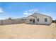 A spacious dirt backyard with block wall and covered patio at 25096 N 154Th Ln, Surprise, AZ 85387