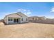 A spacious dirt backyard with block wall and covered patio at 25096 N 154Th Ln, Surprise, AZ 85387
