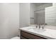 Stylish bathroom features a modern vanity with white marble countertop and sleek fixtures at 25096 N 154Th Ln, Surprise, AZ 85387