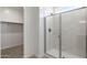 Bathroom featuring frameless shower enclosure adjacent to a walk-in closet for easy access and convenience at 25096 N 154Th Ln, Surprise, AZ 85387